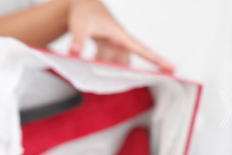 Thumbnail of the woman holding a red shoe box
