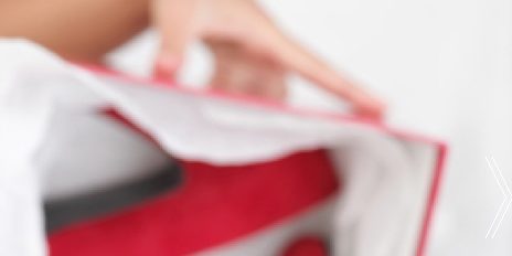 Thumbnail of the woman holding a red shoe box
