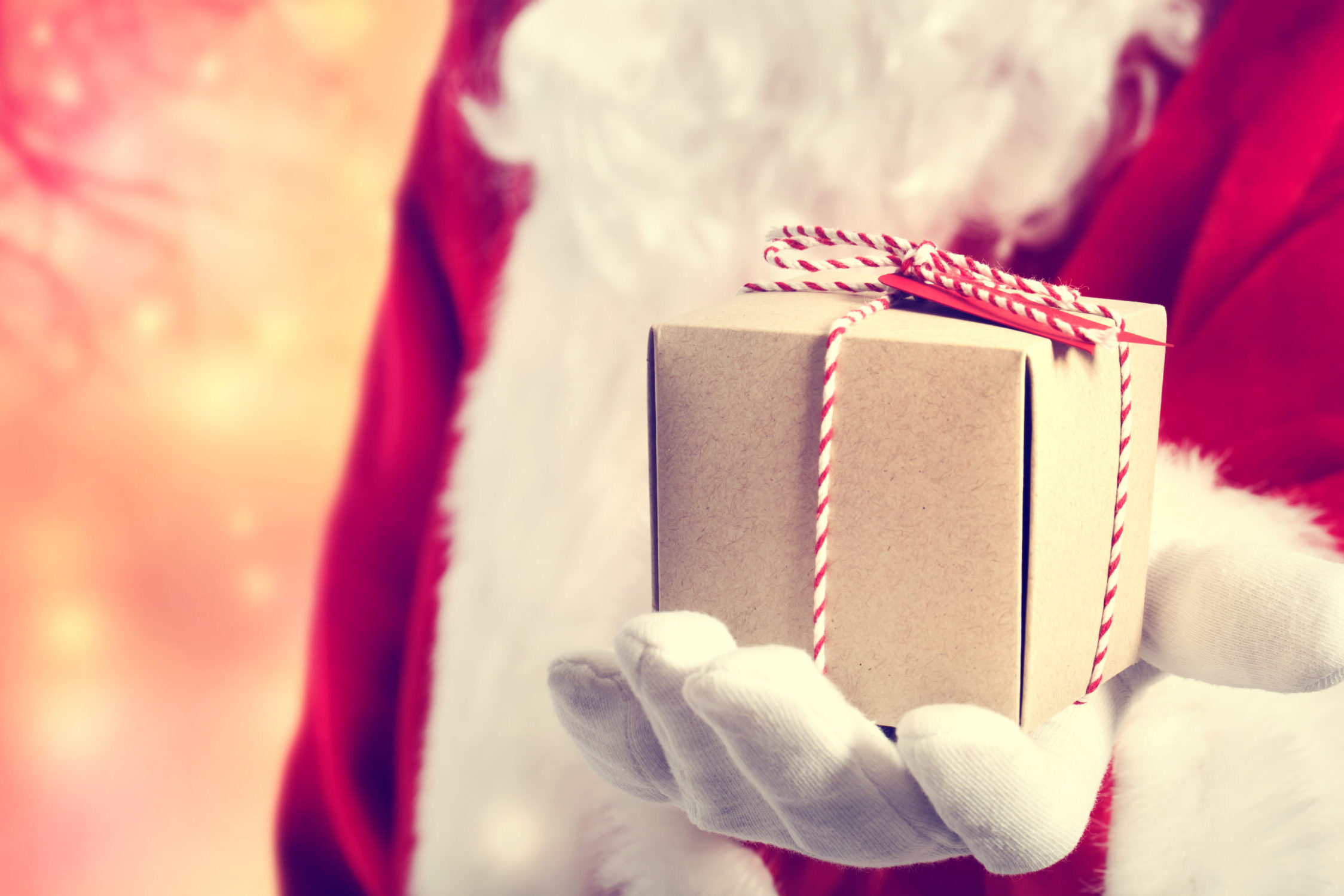 Santa holding a small wrapped box