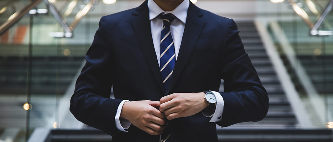 man_in_suite man buttoning up suite