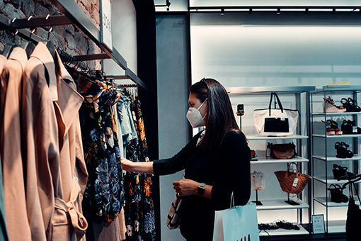 Woman shopping clothes wearing covid mask