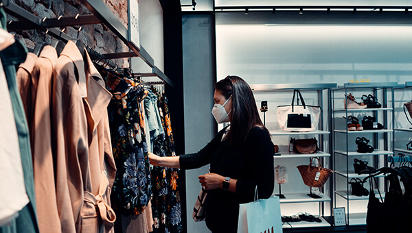Woman shopping clothes wearing covid mask