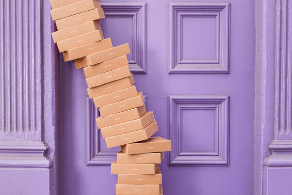 brown boxes stacked in front of a purple door