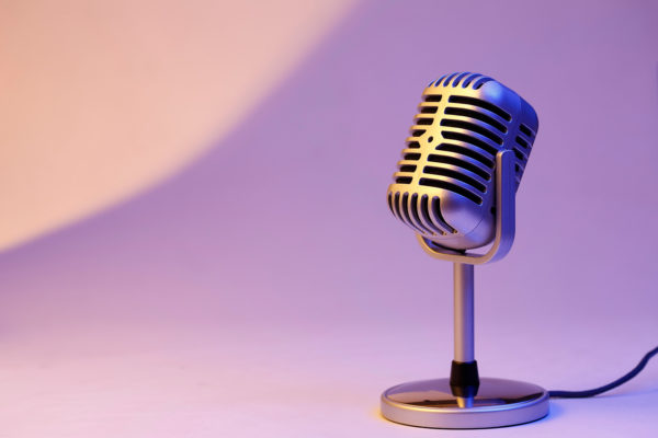 Retro microphone isolated on color background