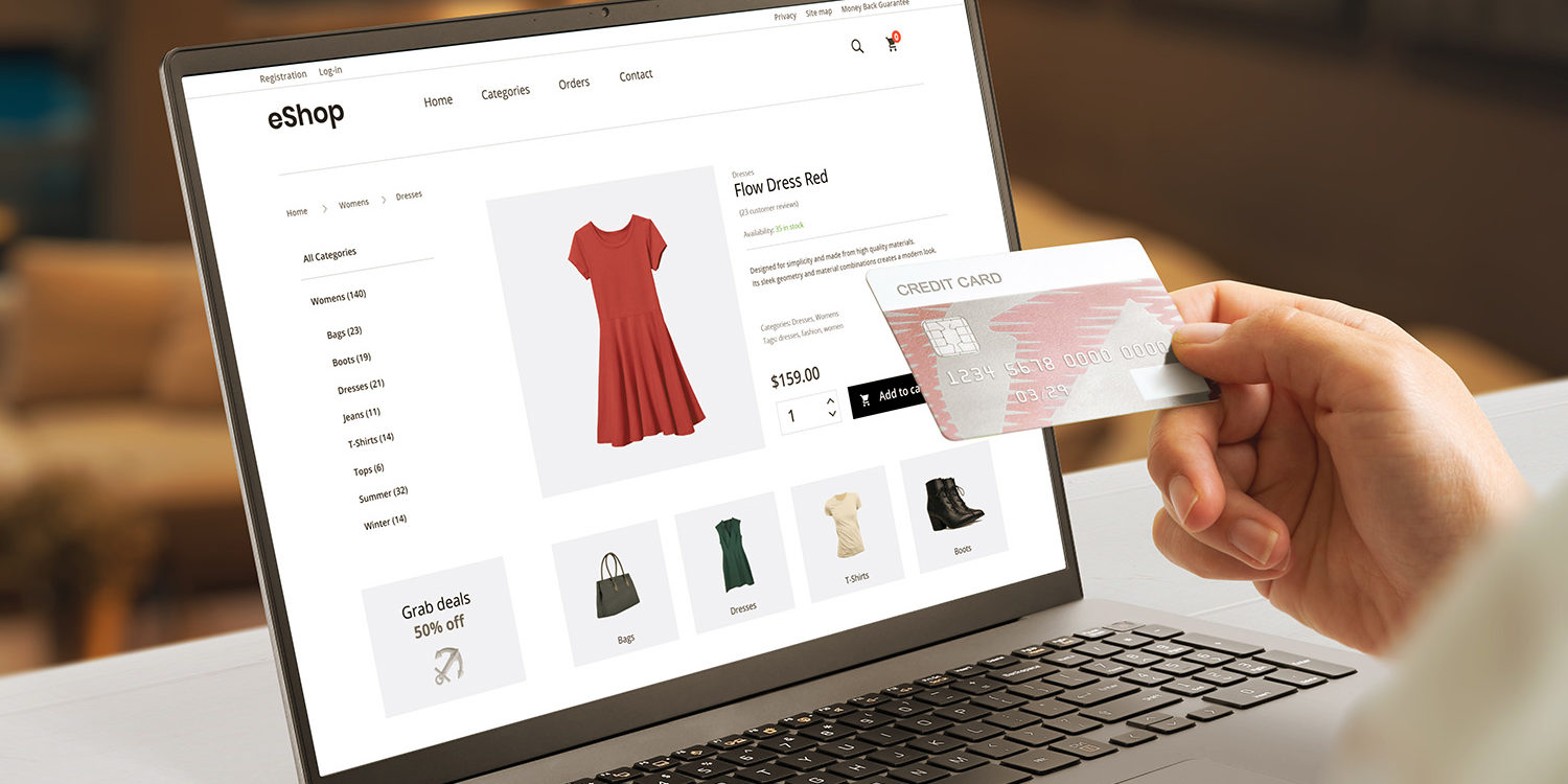 Shopping online with credit card concept modern ecommerce web page with woman clothes on laptop display