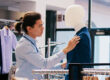 Man inspecting a blue suit in a store