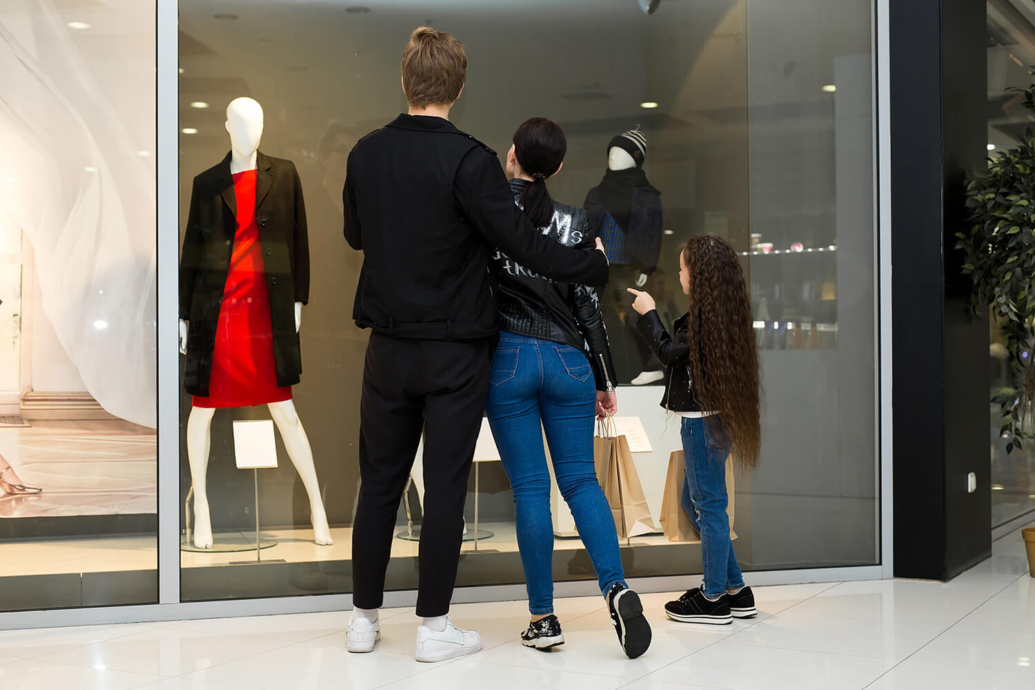 Family looking at clothing on display at a luxury retail store location