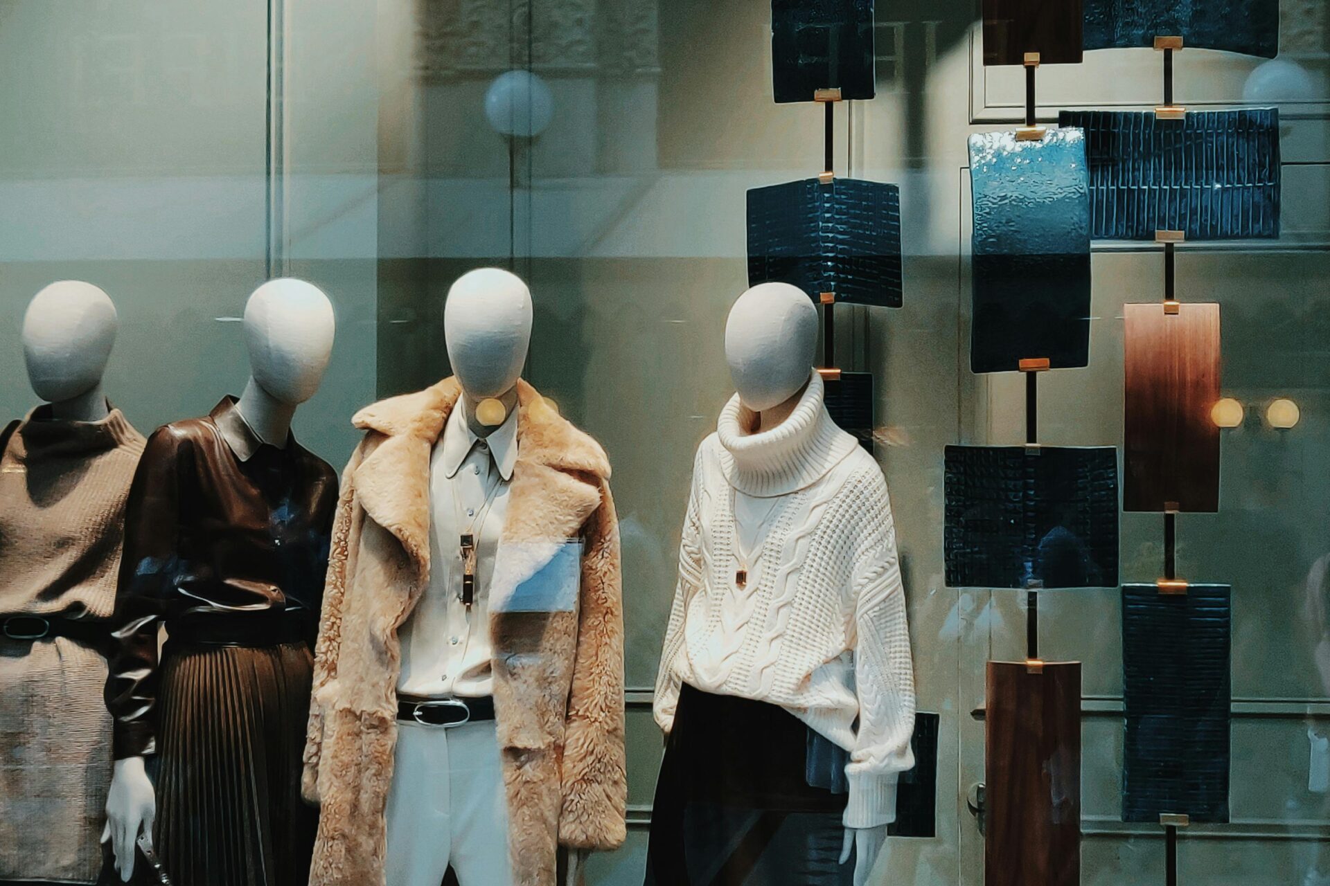 mannequins in luxury retail store window