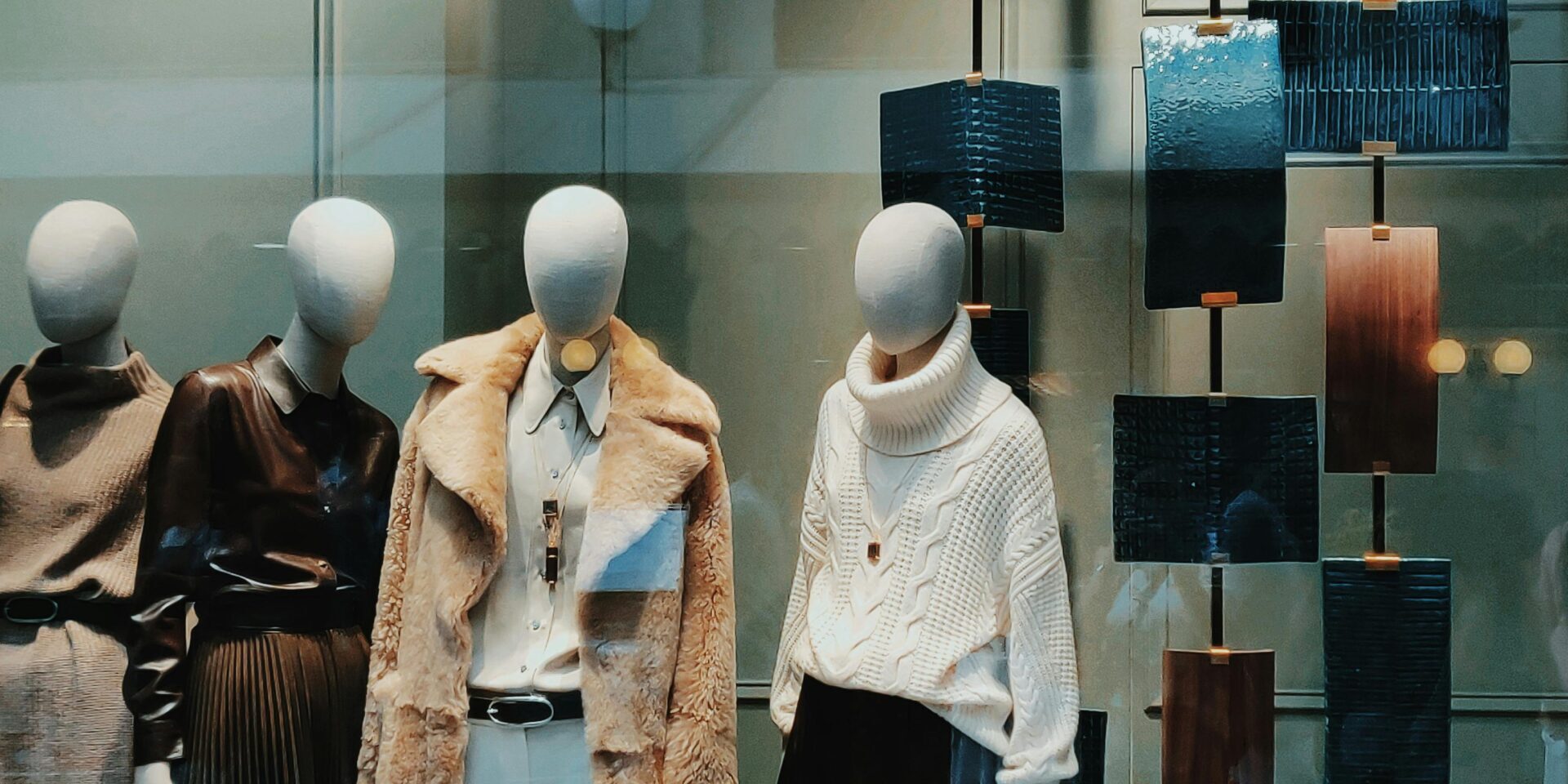 mannequins in luxury retail store window