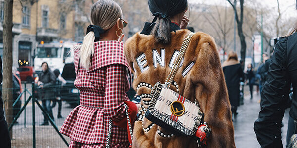 Image Credit: Milan, Italy - February 22, 2018: Fashionable girls wearing Fendi clothing posing after Fendi fashion show during Milan Fashion Week - street style concept. By: agcreativelab | Adobe Stock